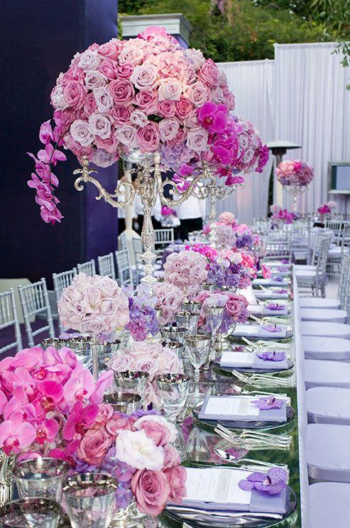 Wedding - Tall Silver Topiaries Are Lush With Pink Roses And Vibrant Orchids, Complimenting This Feminine Wedding Color Scheme.
