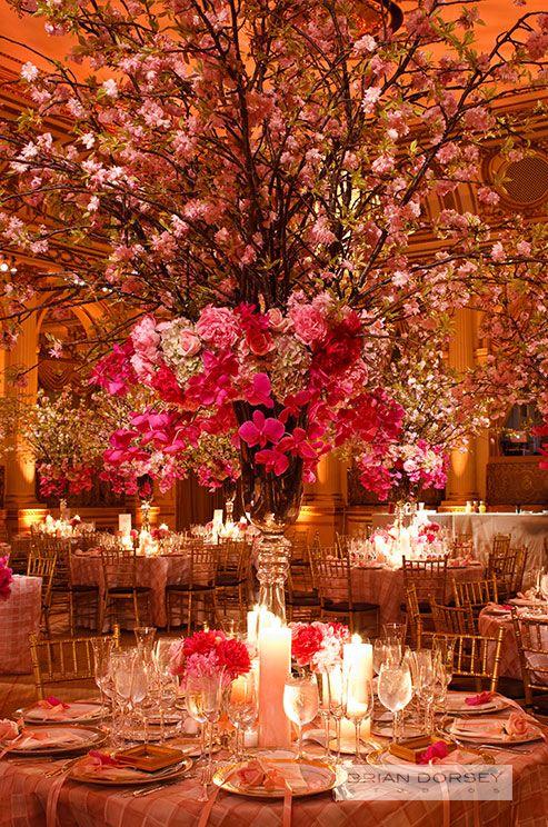 Hochzeit - A Grand Wedding Centerpiece Of Orchids And Romantic Cherry Blossoms Serves As A Focal Point For This Elegant Indoor Wedd...