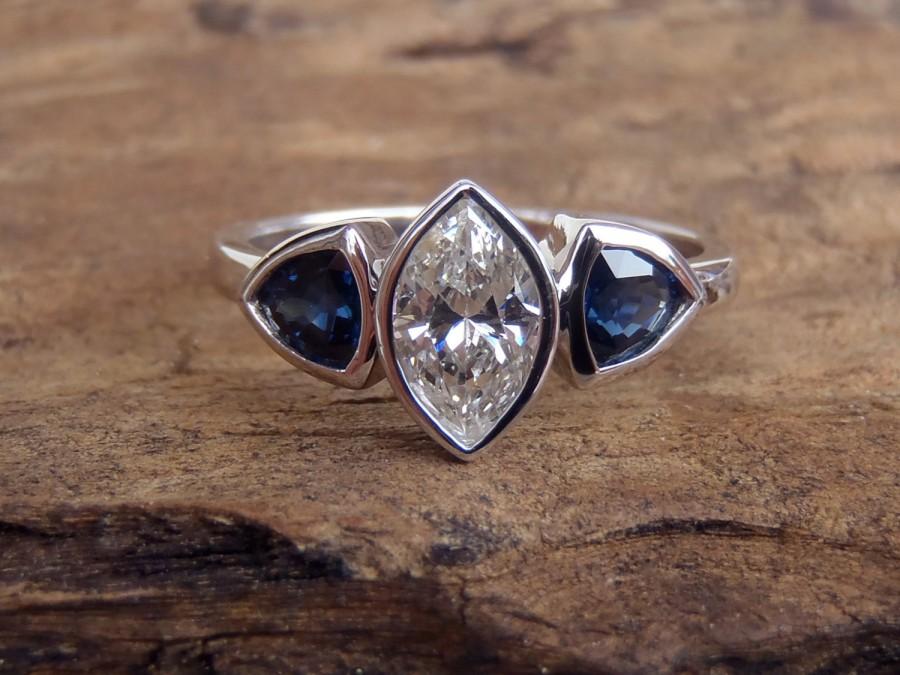 زفاف - Diamond and Sapphire Engagement/Right Hand Ring with 0.5 Ct Center Marquise Diamond and 0.29 Ct Blue Trillion Sapphires x 2.