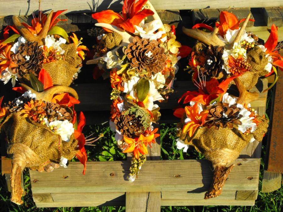 Wedding - Antler shed wedding flowers with orange tiger lily ,pinecone roses and burlap flowers designed to compliment the camouflage wedding