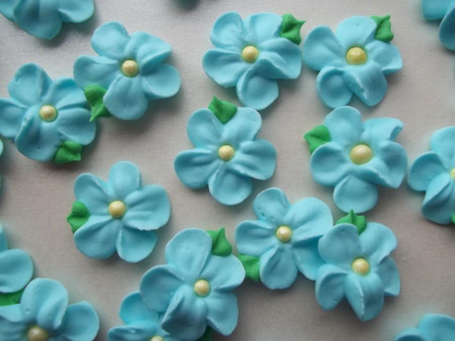 Hochzeit - Small light blue royal icing flowers with attached leaves -- Edible handmade cake decorations cupcake toppers (24 pieces)