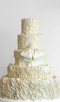 wedding photo - Five-layered Wedding Cake with a white colored bow.