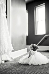 wedding photo - Flower Girl Looking At Wedding Dress.