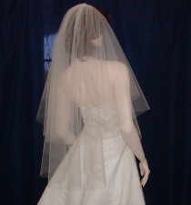 wedding photo - A Softly flowing Circle of Tulle makes up this 2 tier Fingertip Length Bridal Veil 