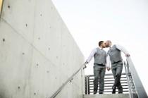 wedding photo - A snack for the eyes: two gorgeous grooms and their secret rainbow cake