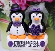 wedding photo - A penguin couple wedding cake topper. / Purple roses