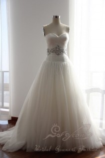 wedding photo - Strapless misty tulle ball gown features crystal hand-beaded dropped waist with a sweetheart neckline in the full tulle skirt