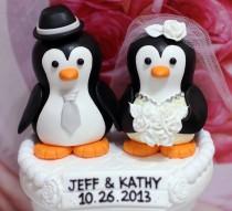 wedding photo - A penguin couple wedding cake topper. / white roses