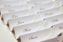 wedding photo - White Wedding place cards with pearls and feather decor 